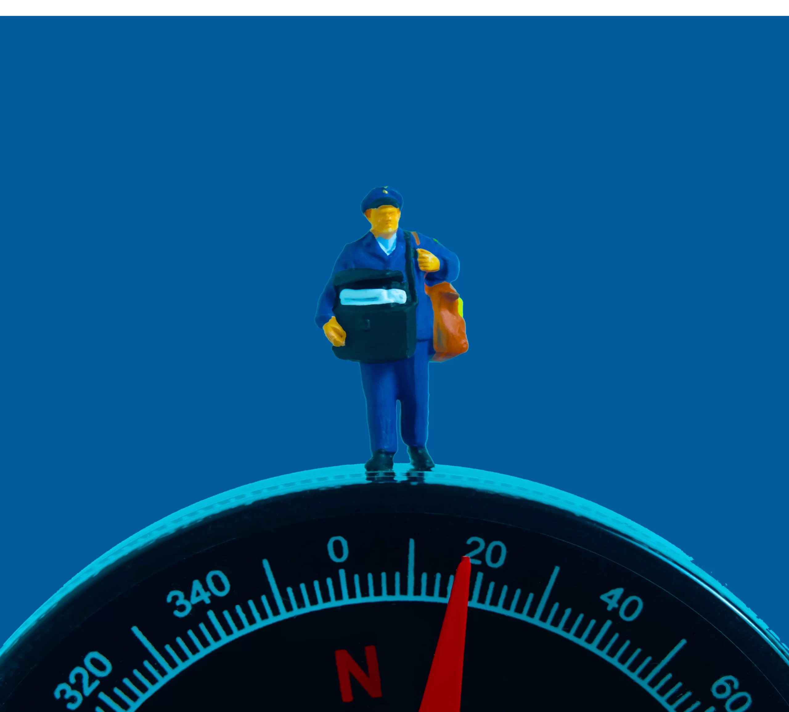 A toy man standing on a compass.
